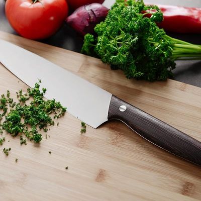 Berghoff Essentials Chef's Multifunctional knife stainless steel blade for veggies, meat, fish or poultry with dark wooden crack-resistant handle 20 cm